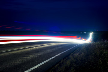 The headlights of the car are on long exposure.