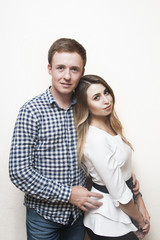 Fototapeta premium Happy loving guy with a girl on a light background