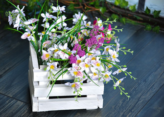 Beautiful composition of summer flowers in a white flowerpot
