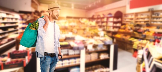 Composite image of young model holding bag with vegetables