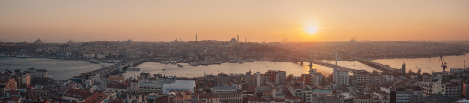 Istanbul sunset panorama - Turkey travel background. Extra wide panoramic photo of Istanbul, Turkey. Autumn cityscape with Golden Horn, shot taken from the viewpoint of Galata tower