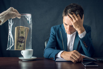 Man Businessman in suit arrested for taking bribe. Caught red-handed. Concept of corruption and...