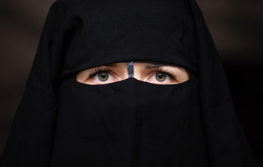 Green eyed young european woman wears hijab.