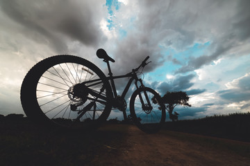 Mountain biking on road with storm 
