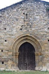 Fototapeta na wymiar Old entrance of the church of Santa Maria de Lillet in La Poble de Lillet, Bergueda,