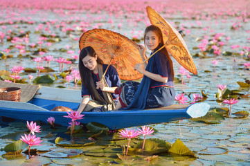 Laos woman in flower lotus lake, Woman wearing traditional Thai people , Red Lotus Sea UdonThani...
