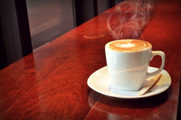 white cup of hot coffee in coffee shop 