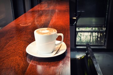 white cup of hot coffee in coffee shop 