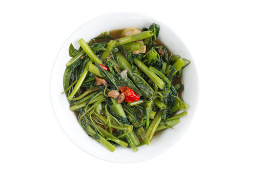 Stir fried morning glory with garlic,bean paste and chilli ,isolated white background..You are what you eat,try meatless meals ,healthy lifestyle concept