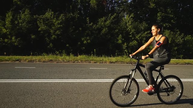 a woman rides a Bicycle on the road