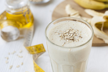 Banana oatmeal Breakfast smoothie on a white wooden table