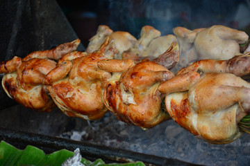 Close up grilled whole chicken on stove