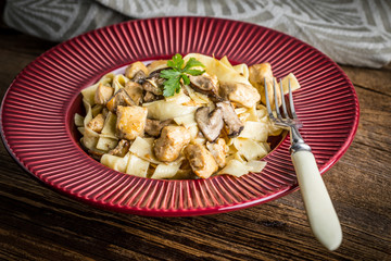 Tagliatelle pasta with forest mushrooms and chicken.