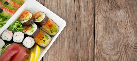 Composite image of sushi served in tray over white background