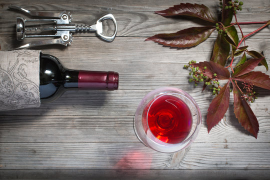 Red wine bottle,corkscrew,glass. Top view still life