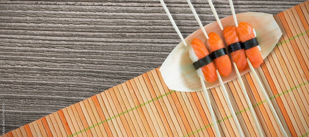 Poster composite image of close up of salmon sushi with chopsticks in