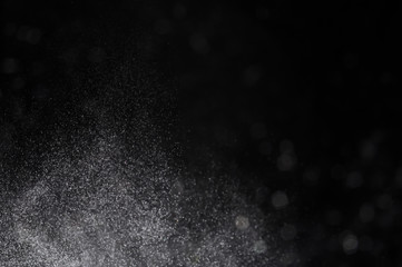 Snowstorm texture,Water dust in motion like snow on black,Watercolor background