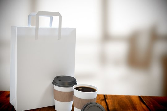 Composite image of disposable coffee cup and parcel bag