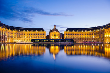 Fototapeta na wymiar Reflection at blue hour of the Bourse Place with tramway in Bordeaux
