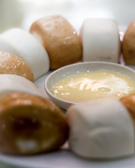 Steamed bun on white plate.
