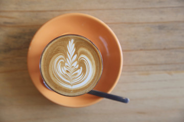 Cappuccino coffee on wood background in coffee shop