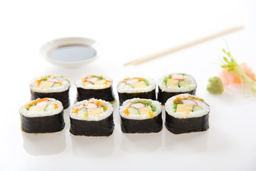 Futomaki sushi , Japanese roll rice egg avocado cucumber and caviar isolated in white background