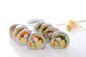 Futomaki sushi , Japanese roll rice egg avocado cucumber and caviar isolated in white background