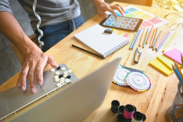 Fototapeta na wymiar creative / fashion designer working on laptop and digital tablet at modern home studio