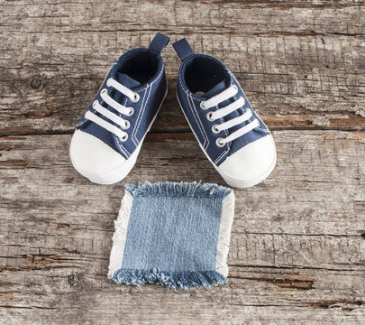 Baby shoes on wooden background