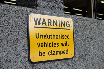 Wheel clamping warning sign