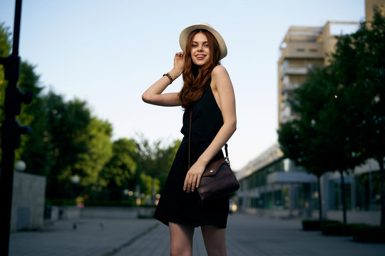 woman in a hat with a bag in the city