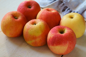 red large apples in droplets of water
