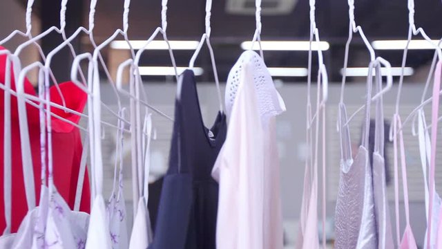 4K Interior of fashionable women's clothes store with clothes racks & mannequins