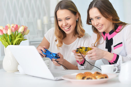 young women playing computer game