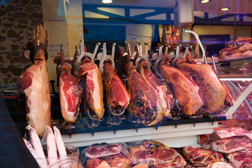 CAMBRILS, SPAIN - AUG 27th, 2017: Spanish ham on a market, jamon iberico in view black leg pork isolated, traditional national spain meat in store, serrano prosciutto food on background gastronomy