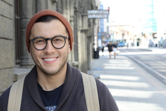 Cute hipster smiling outdoors close up