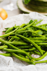Fresh green snap beans on the plate ready to cook