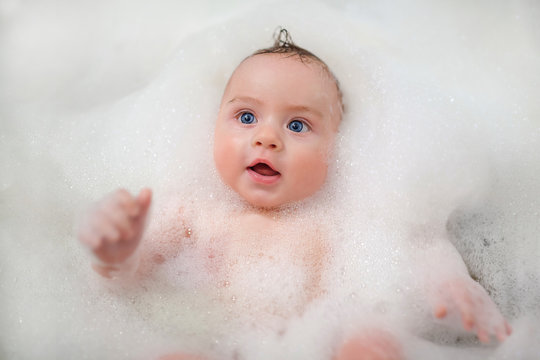 baby bathing in foam