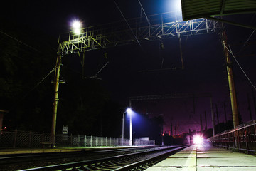 Trains in motion on long exposure at night.