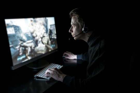 Young gamer in the dark