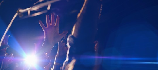 Cropped hands of people cheering in club