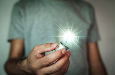 Man holding light bulb.