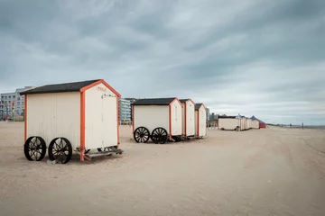 Foto auf Acrylglas Row of colorful beach cabins on a cloudy day on the beach of De Panne, Belgium. © Erik_AJV