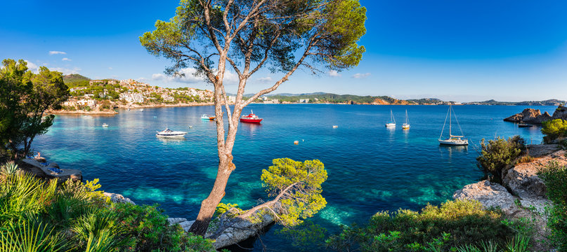 Idyllic panorama island scenery of bay with boats at Cala Fornells on Majorca island, Spain