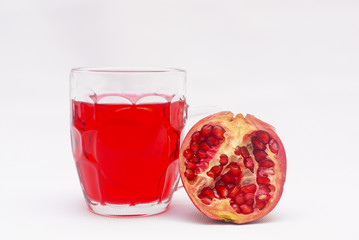 Pomegranate Fruit Cut Into Half And Pomegranate Fresh Juice Over White Background