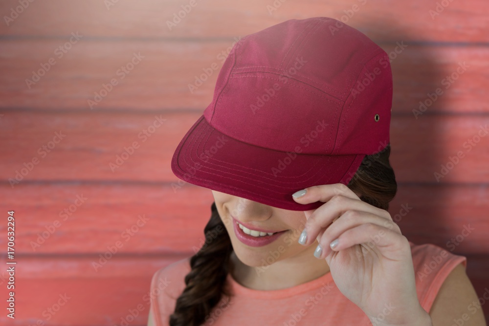 Poster composite image of smiling female model showing red cap