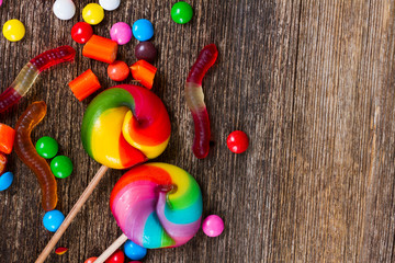 Colorful candies close up on wooden background with cop space