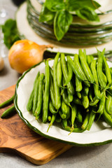 Fresh green snap beans on the plate ready to cook