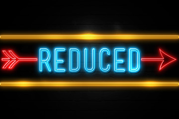Reduced  - fluorescent Neon Sign on brickwall Front view