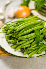 Fresh green snap beans on the plate ready to cook